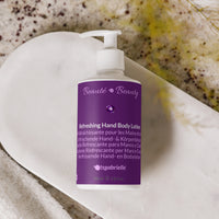 Purple bottle of tsgabrielle refreshing hand body lotion on a textured surface